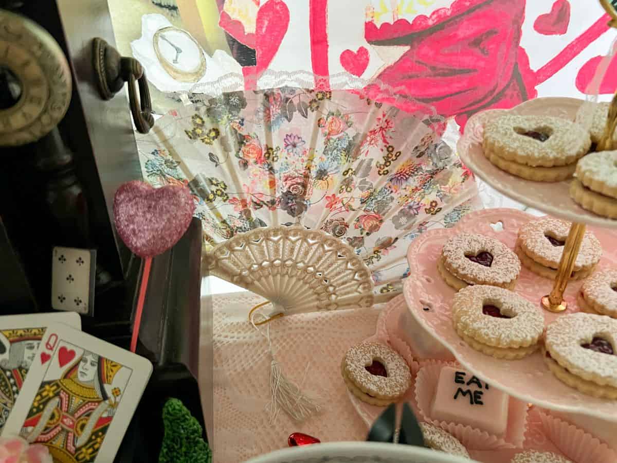 a fan splayed out on an Alice in Wonderland dessert table