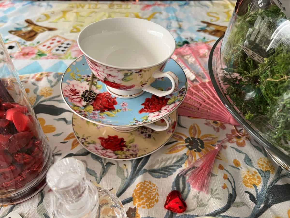 a fancy teacup and saucer on a table runner