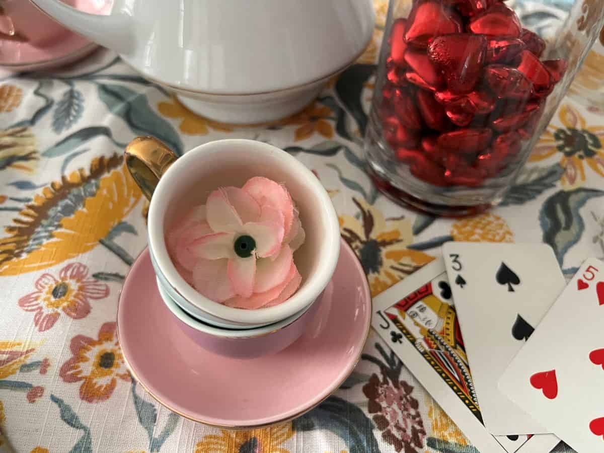 small teacup and saucer with a mini faux rose inside