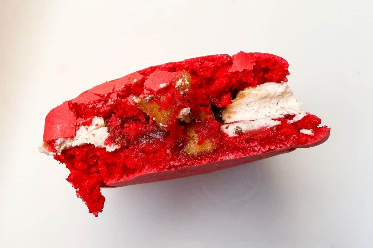 a caramel apple cider macaron cut in half to reveal the inside