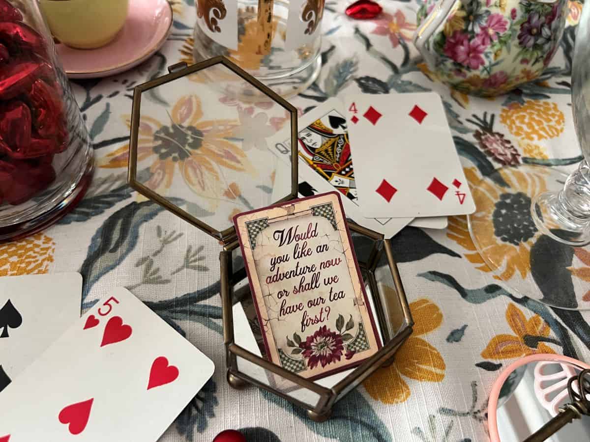 a small glass box with a vintage Alice in Wonderland card