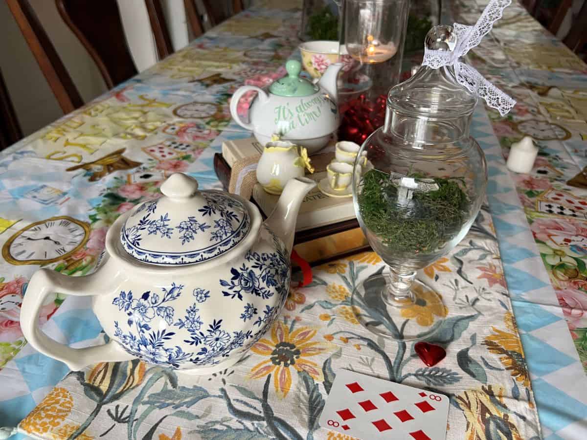 a white and blue teapot on a Mat Hatter's tea party table