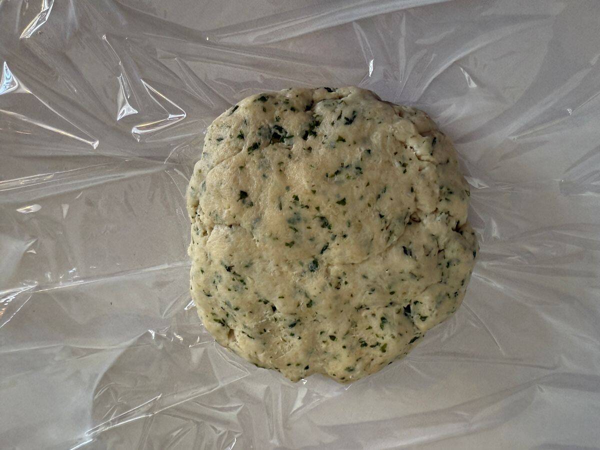 tart dough formed into a disc on a piece of plastic wrap