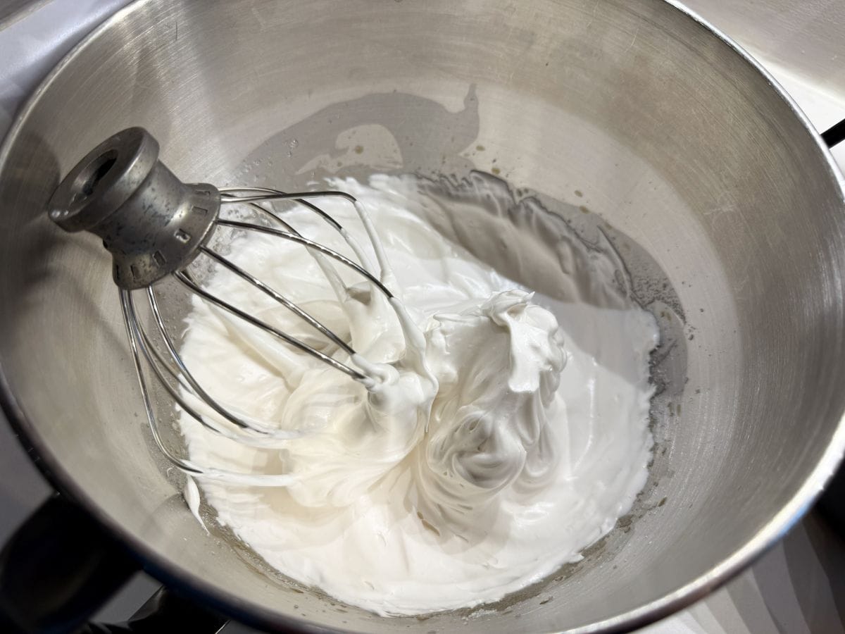 white meringue in a mixer bowl to be used for macarons