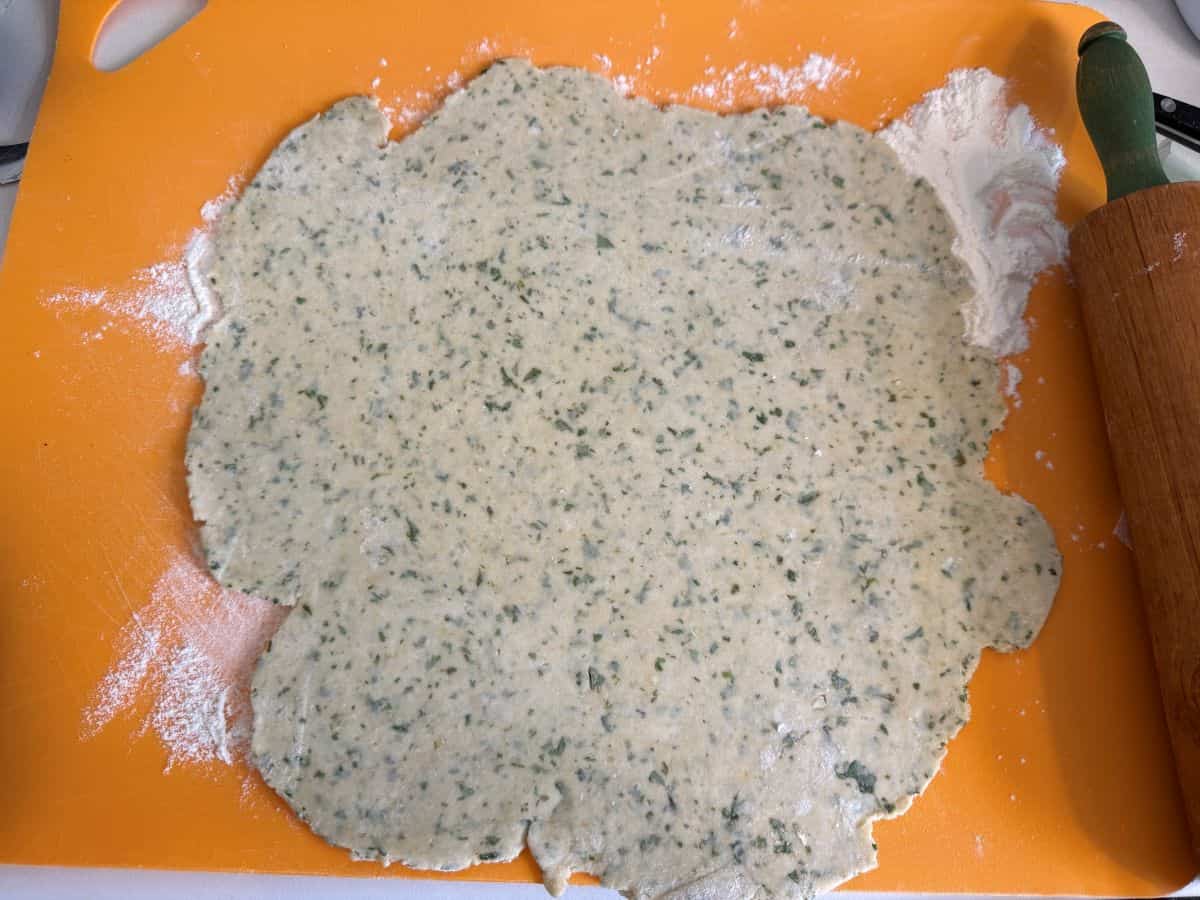 basil tart dough rolled thin on a floured cutting mat