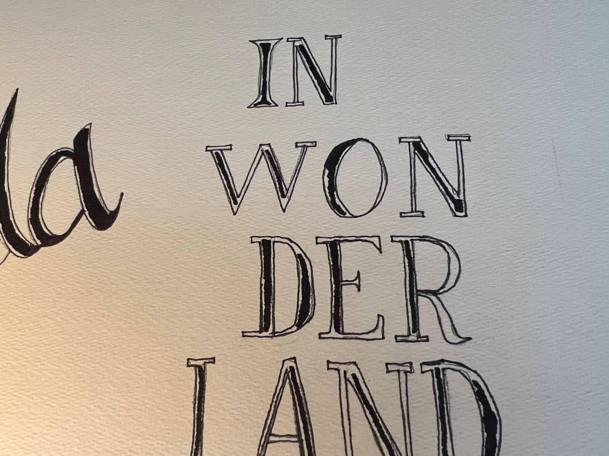 Wonderland lettering outlined in thin black Sharpie and filled in partially with thicker Sharpie
