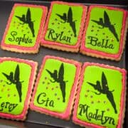Tinkerbell cookies with black Tinkerbell silhouettes sprinkling pixie dust