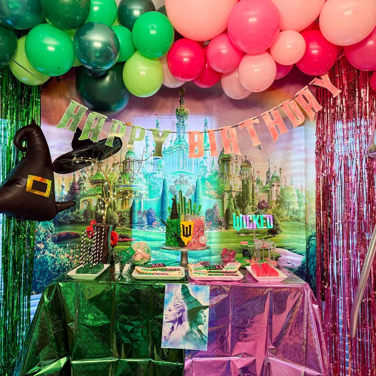 Wicked Birthday Party Dessert Table with the left half green and the right half pink