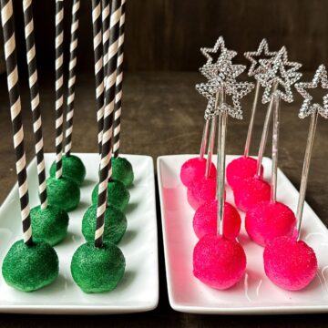 Wicked Cake Pops, which are a plate of green cake pops with black and white striped sticks and a plate of pink cake pops with silver star wand sticks