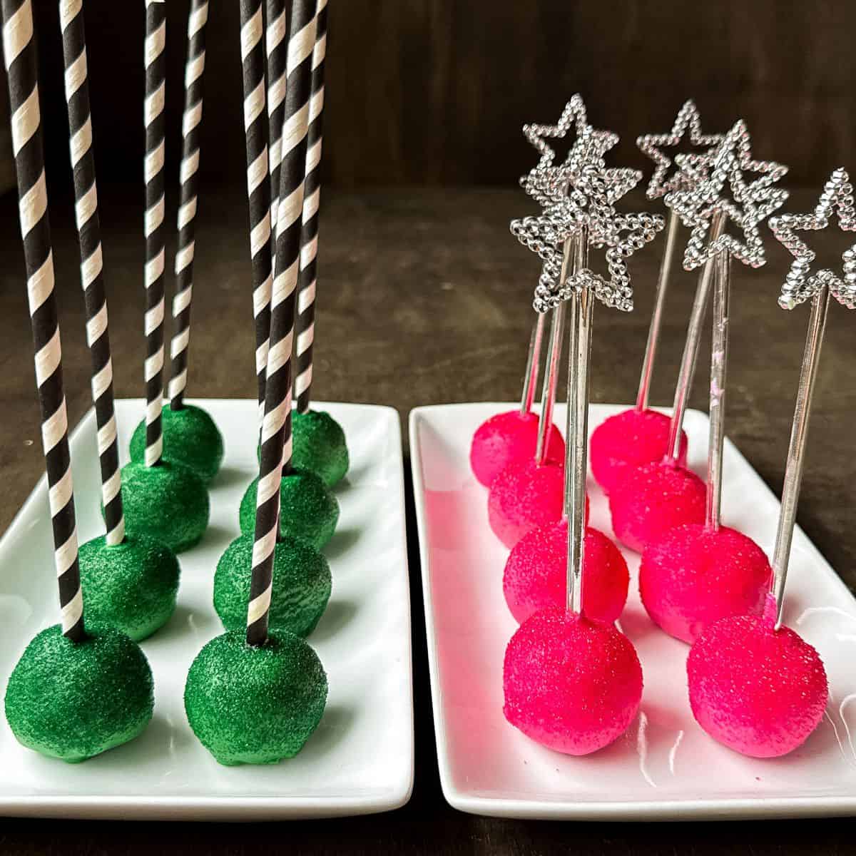 Wicked Cake Pops, which are a plate of green cake pops with black and white striped sticks and a plate of pink cake pops with silver star wand sticks