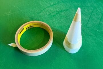 a parchment cone next to a roll of masking tape