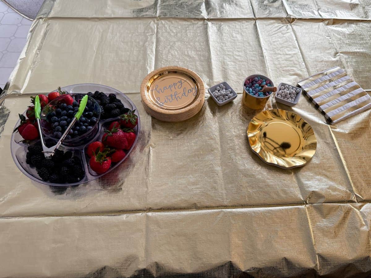 gold paper plates on a gold tablecloth covered table