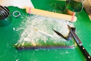 black fondant rolled around a drinking straw to create a broomstick