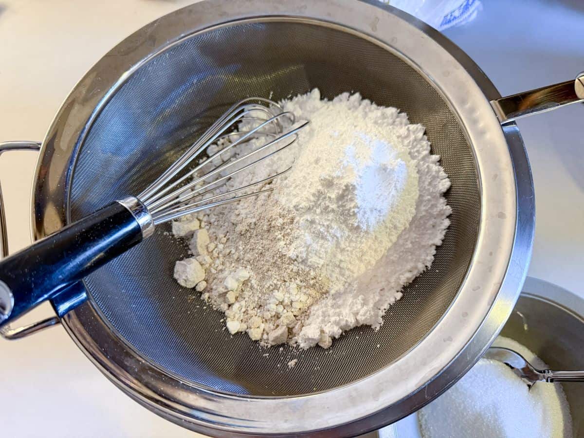 dry ingredients in a fine mesh sieve with a wire whisk set over a bowl