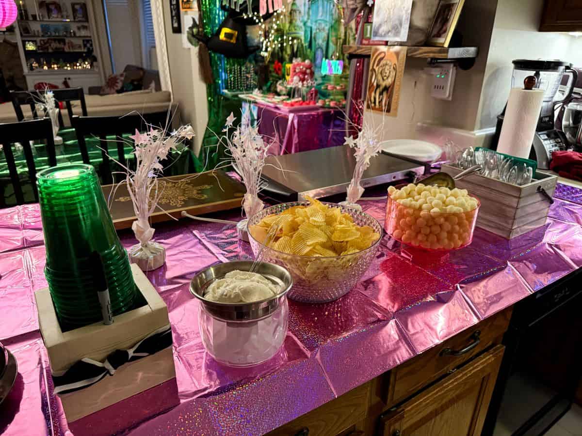 a kitchen peninsula set up with snacks and treats for a Wicked Birthday Party