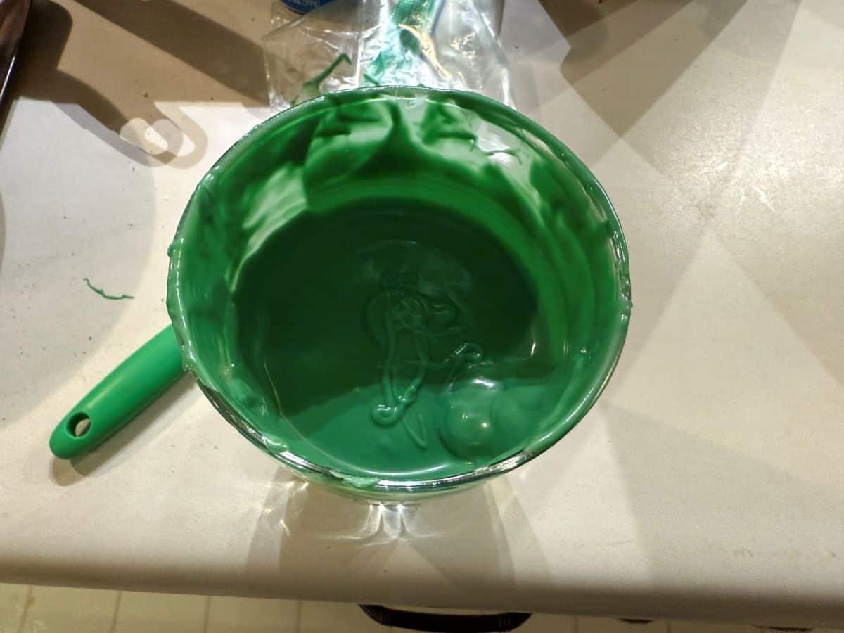 melted green candy melts in a glass