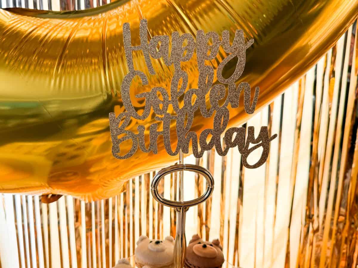 gold glitter cardstock cut to read "Happy Golden Birthday"