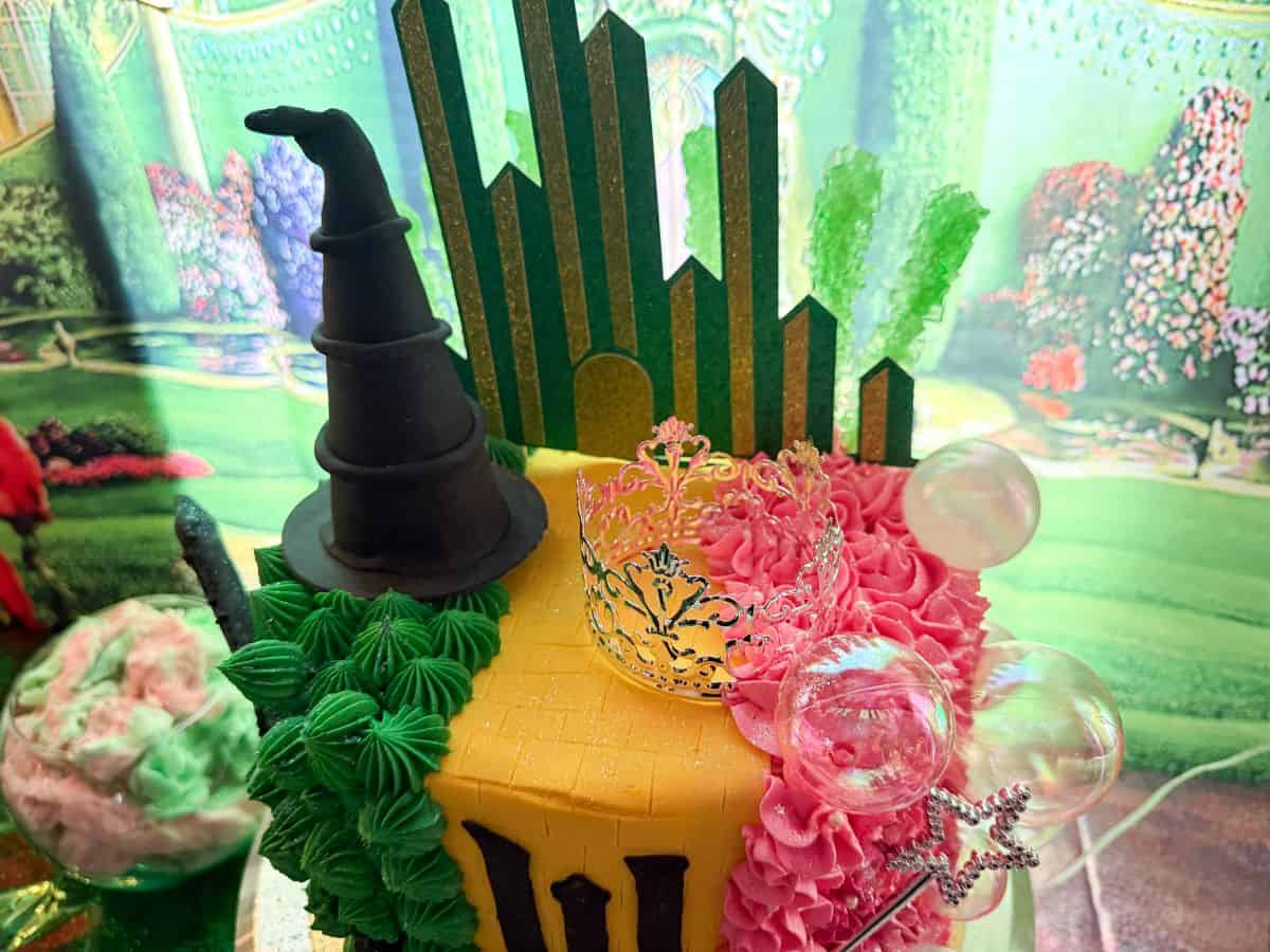 the top view of a Wicked cake that shows the decorations like a witch hat and silver crown