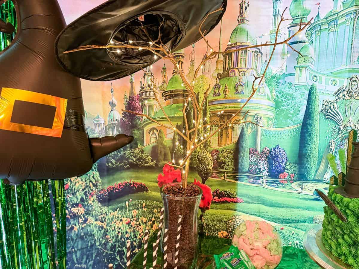 twigs in a vase of coffee beans with string lights on them