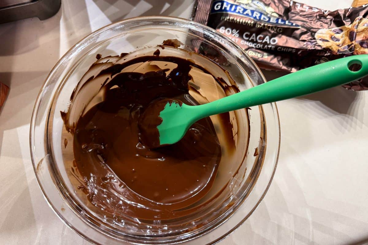 chocolate melted in a glass bowl with a small silicone spatula