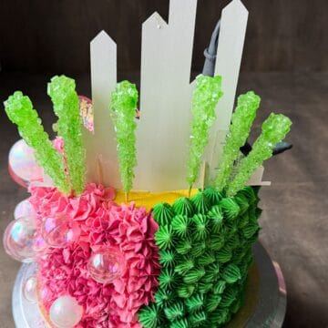 green rock candy on sticks inserted into a Wicked cake