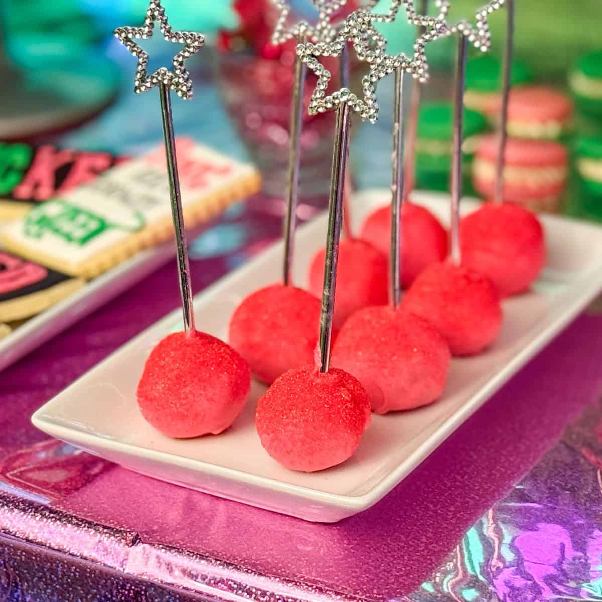 Glinda Cake Pops that are pink with silver wand sticks