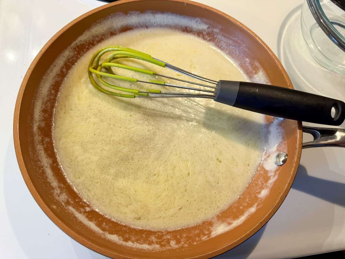 browned butter in a small skillet with a whisk in it