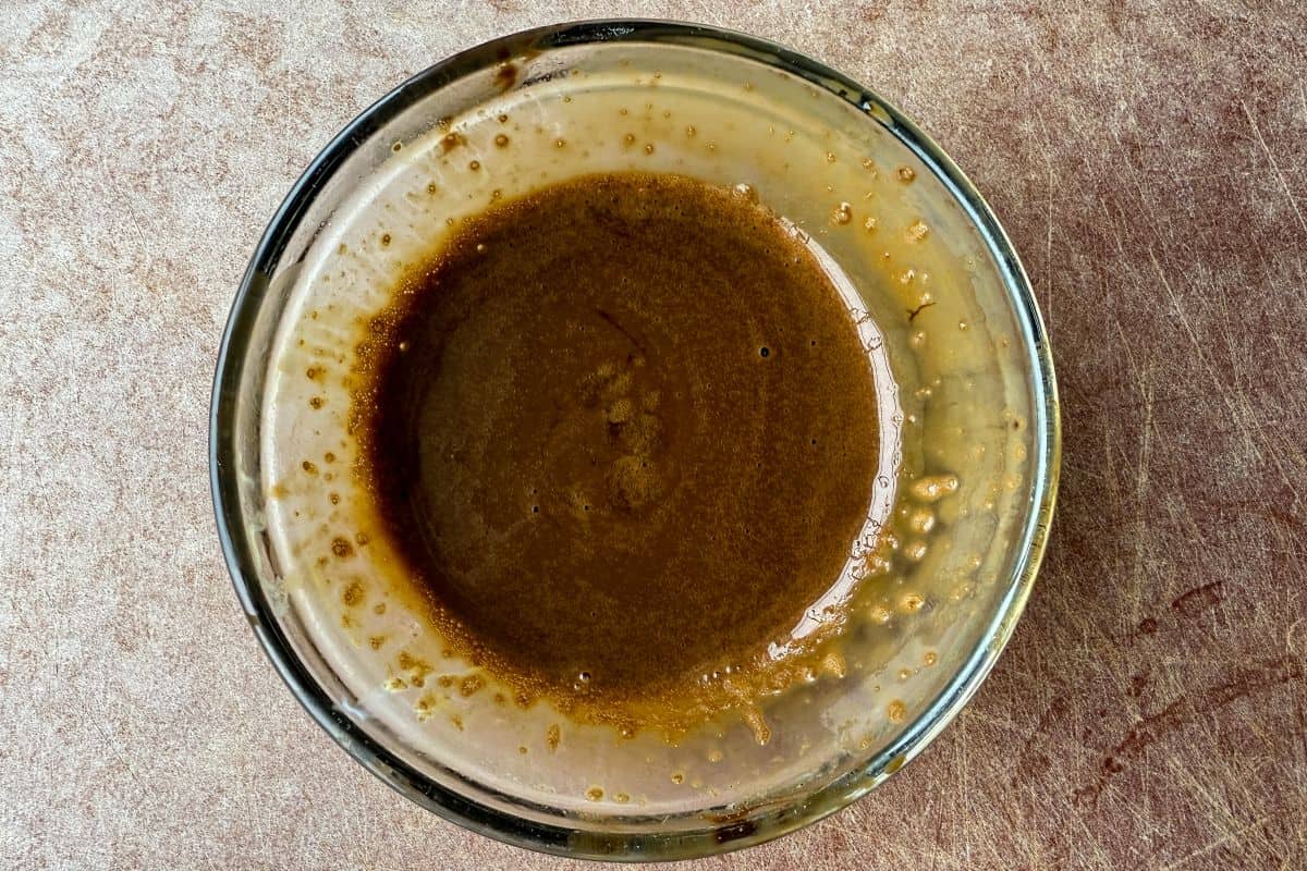 espresso powder dissolved in water in a small glass dish