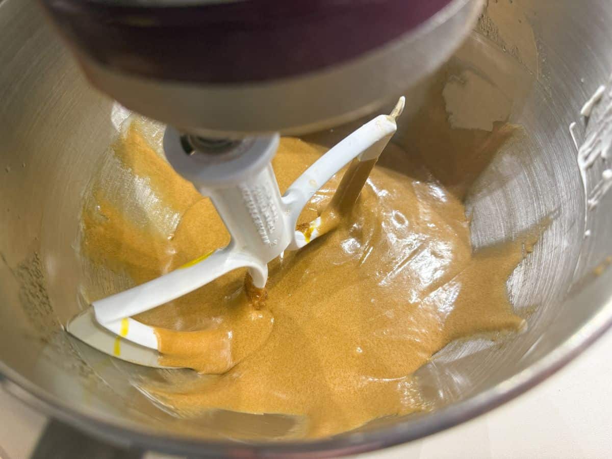 batter in the bowl of a stand mixer with the beater running