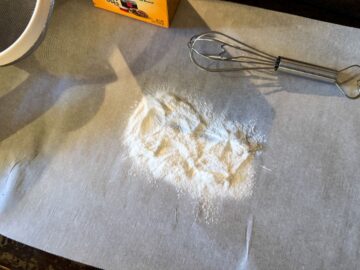 sifted baking soda on a parchment lined cookie sheet