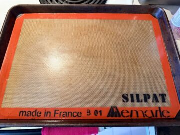 a silpat mat on a half sheet pan