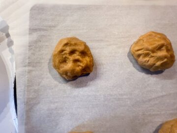 a flattened ball of dough with little divots in the top