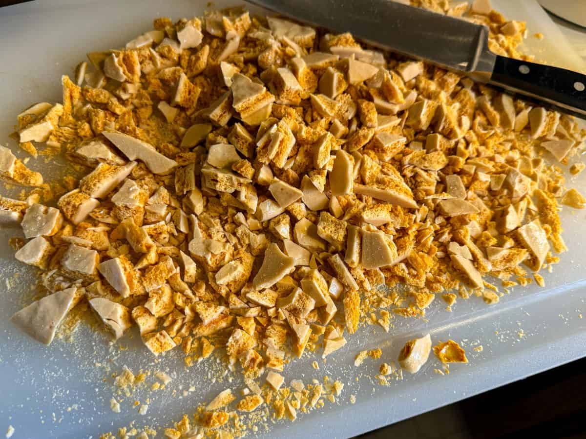a cutting board covered in chopped coffee crunch honeycomb candy