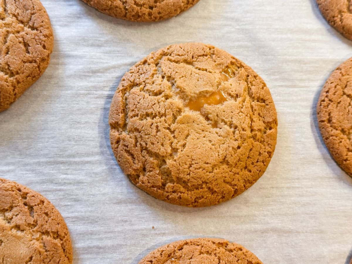 a caramel browned butter cookie on a parchment lined cookie sheet