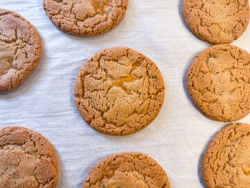 caramel browned butter cookies on a parchment lined cookie sheet