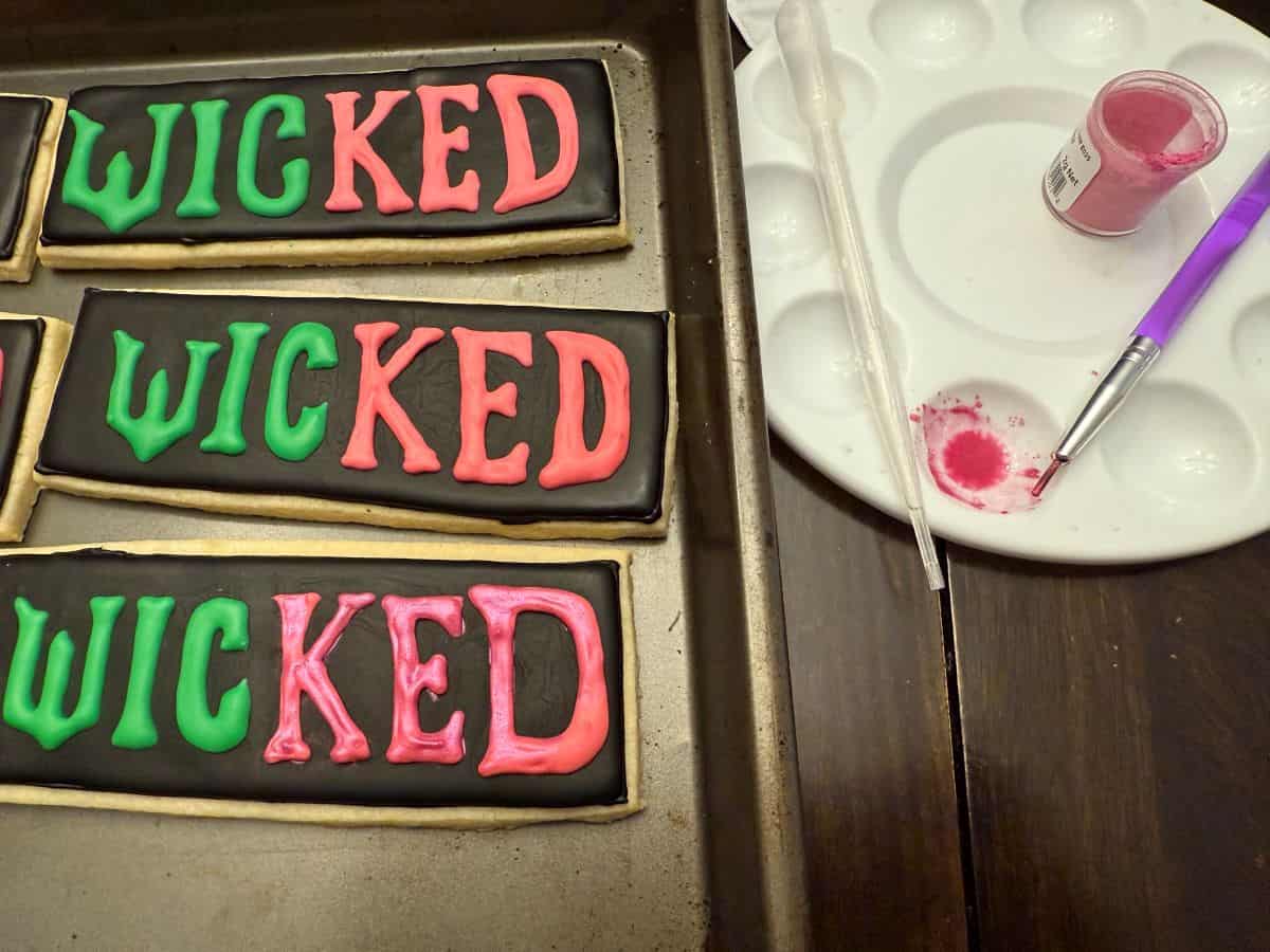 wicked cookies with a paint palette filled with pink luster dust suspension 