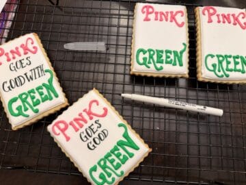 white royal icing cookies with black edible marker to write on cookies "Pink goes good with green"
