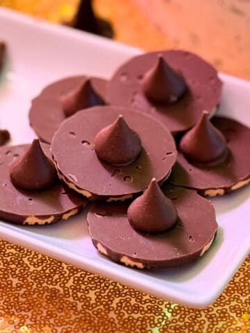 Easy Chocolate Wizard Hat Cookies stacked on a white plate