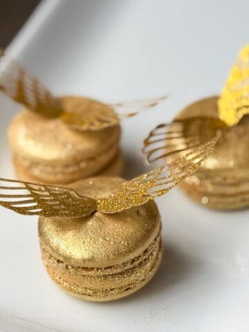 Nut Free Golden Snitch Macarons on a white plate