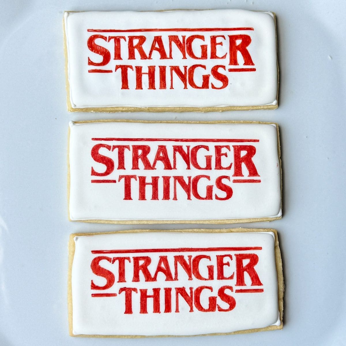 three Stranger Things Cookies on a white plate