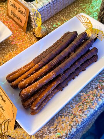Wizard Wand Chocolate Pretzels stacked on a white plate