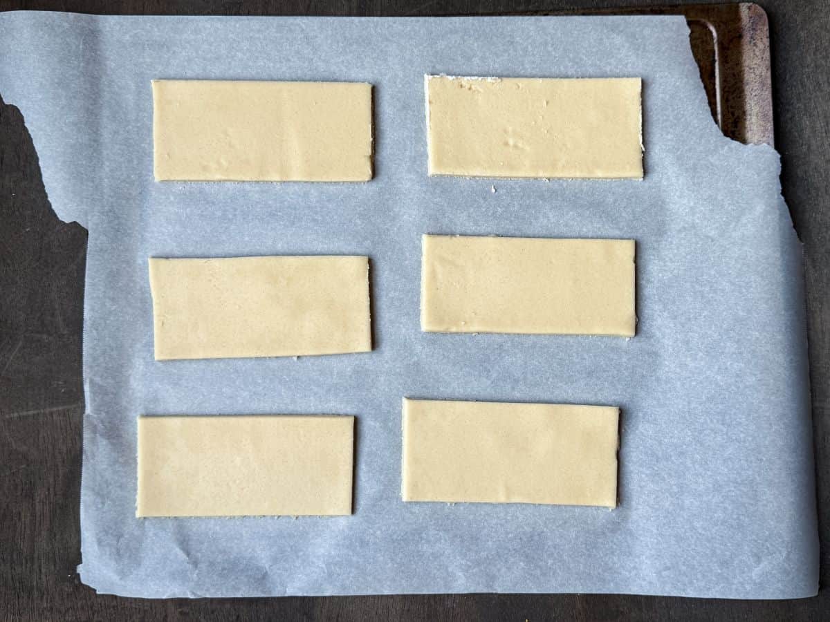 rectangular cookies before baking on a parchment lined cookie sheet