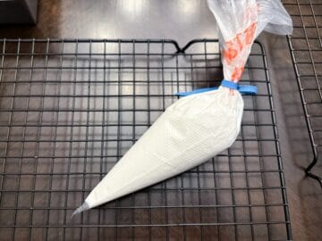 outline consistency royal icing in a disposable piping bag secured with a rubberband