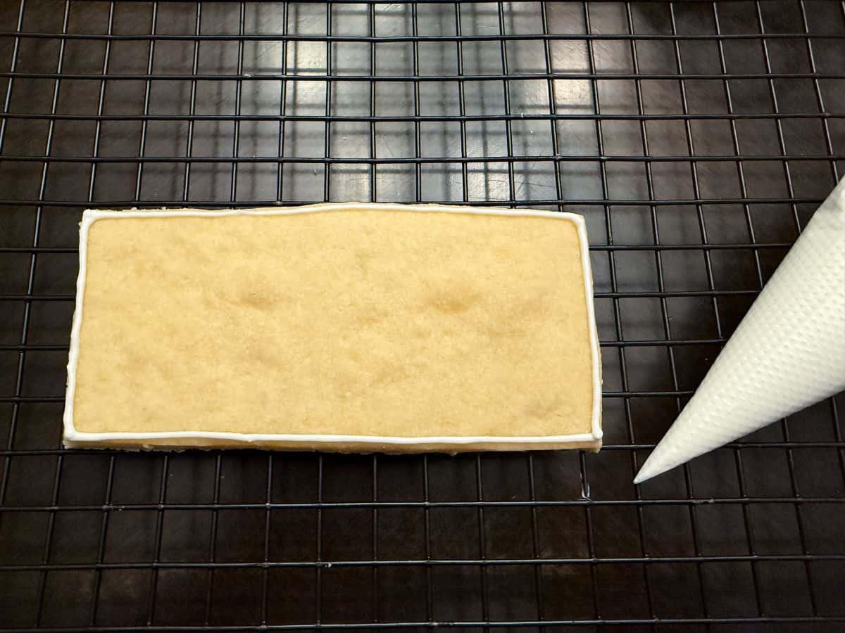 a rectangular cookie outlined with white royal icing