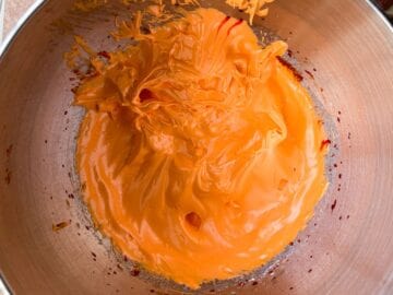 orange meringue in a metal mixing bowl