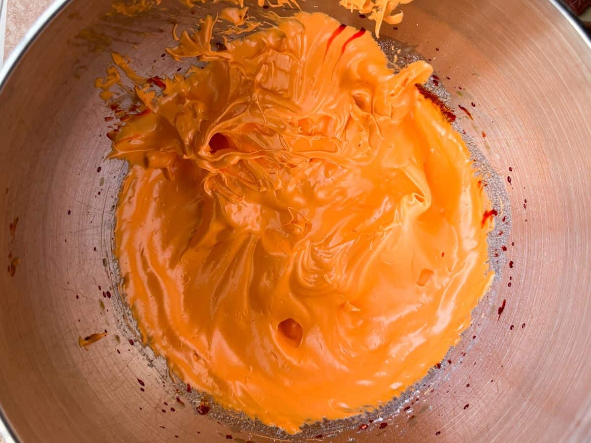 orange meringue in a metal mixing bowl