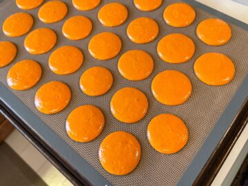 nut free macaron batter piped on a macaron mat