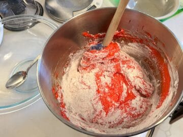 dry ingredients being incorporated into meringue in a process called macaronage