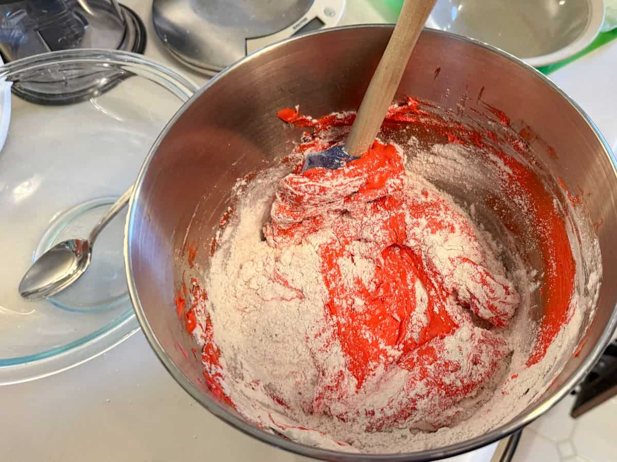 dry ingredients being incorporated into meringue in a process called macaronage