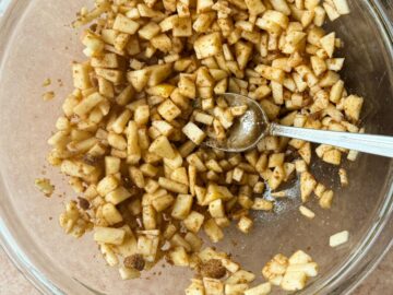 a caramel apple filling mixture in a glass bowl before being cooked